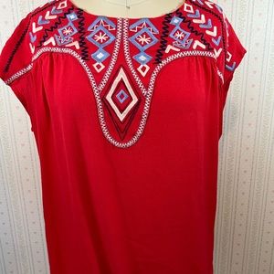 Red shirt with embroidered shapes. Loose fitting boho festival modest chic.